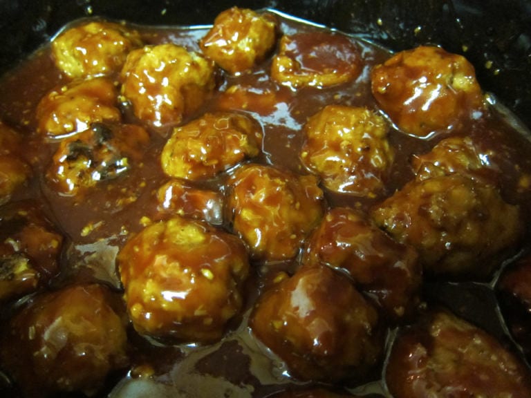 Just a bunch of tasty meatballs hanging out in a crockpot full of honey garlic bbq sauce!